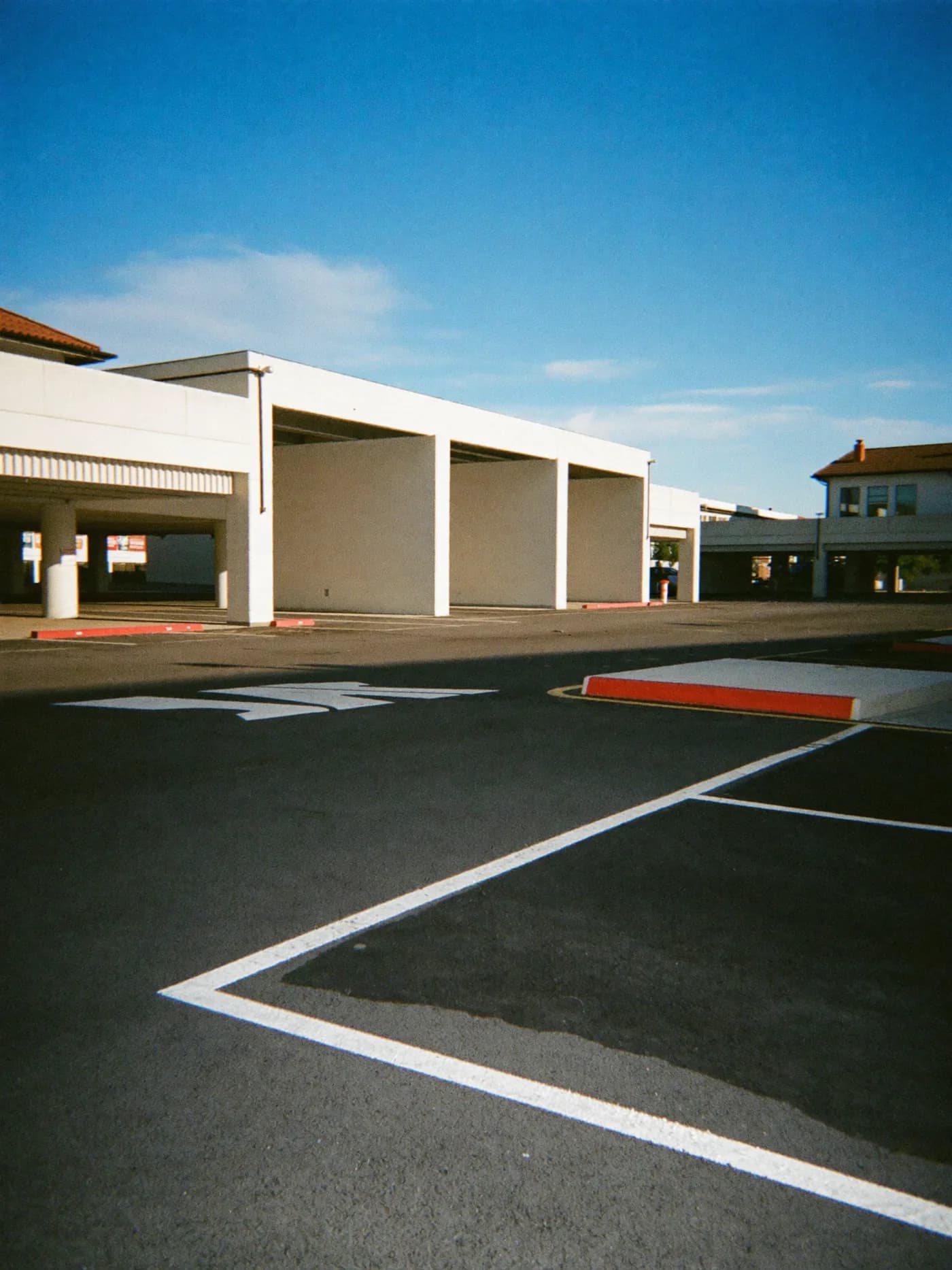 FORMA brand environment, a sunlit concrete lot, calm and architectural.